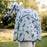 A grey pony wearing the Horseware Ireland Amigo Bug Rug Plus Pony fly sheet in a dragonfly print, close up on the back tail flap of the blanket.