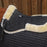 Black quilted saddle pad with beige fleece lining on a horse.